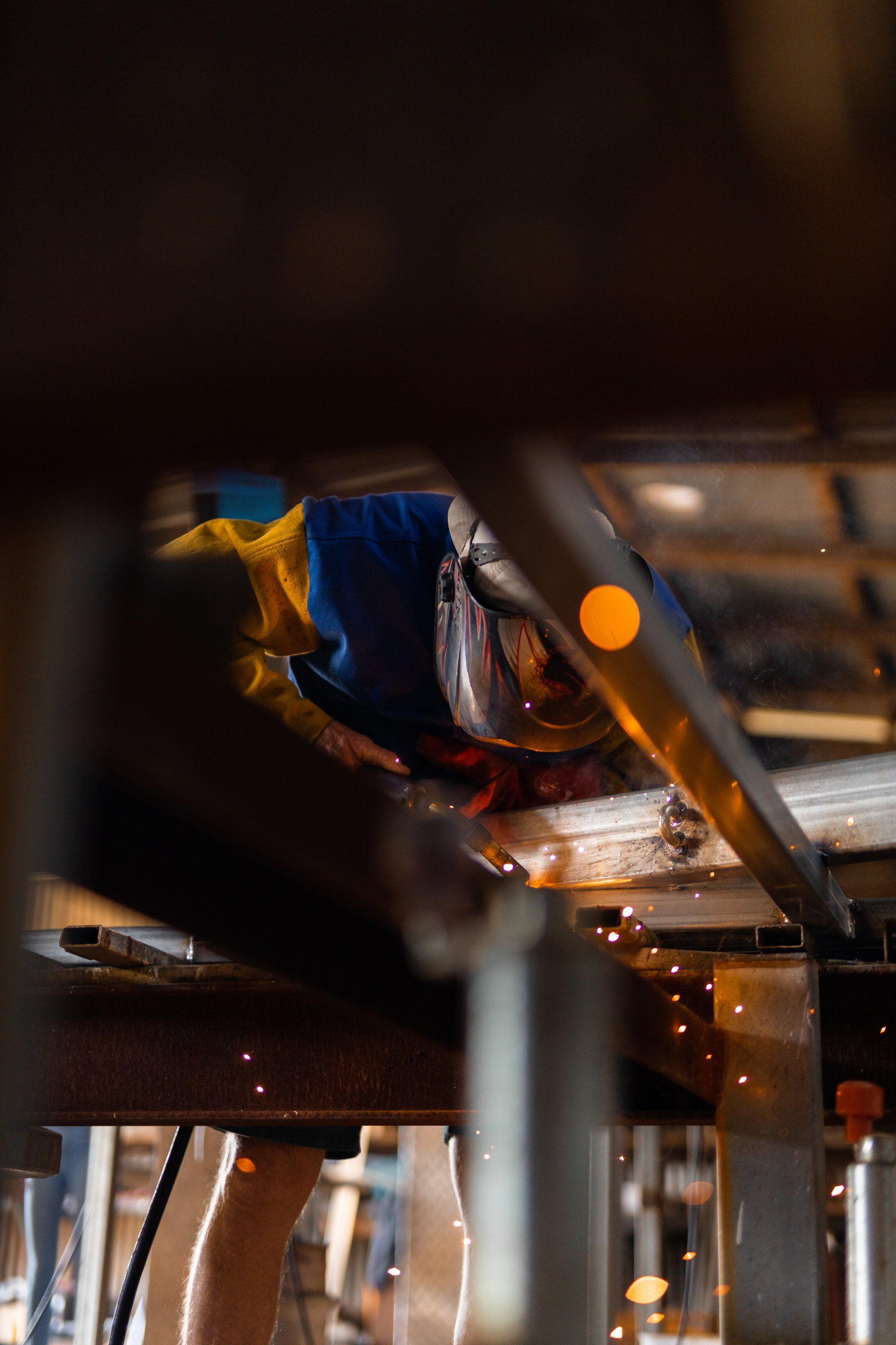 Close-up of a small orange light and wires inside a metal structure, with blue insulation in the background