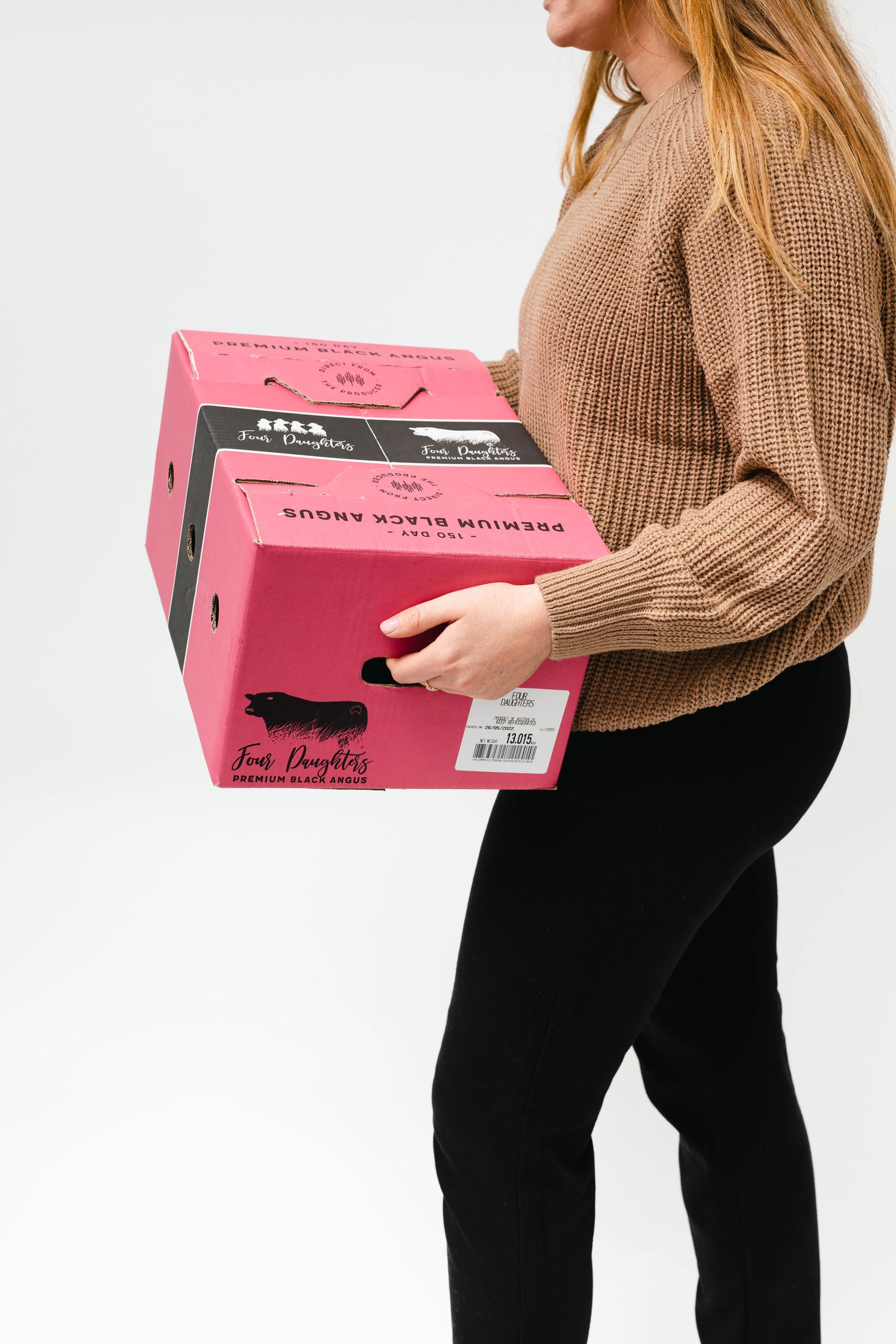 Person carrying two pink boxes against a white background