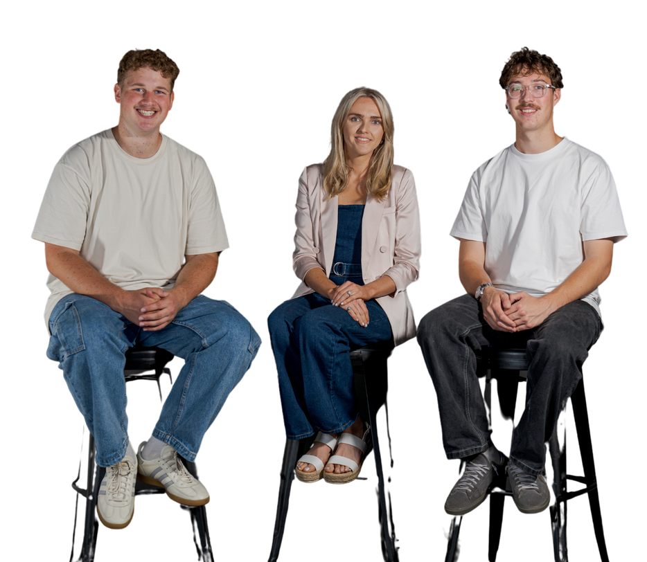 Three people seated on stools against a white background, smiling at the camera.