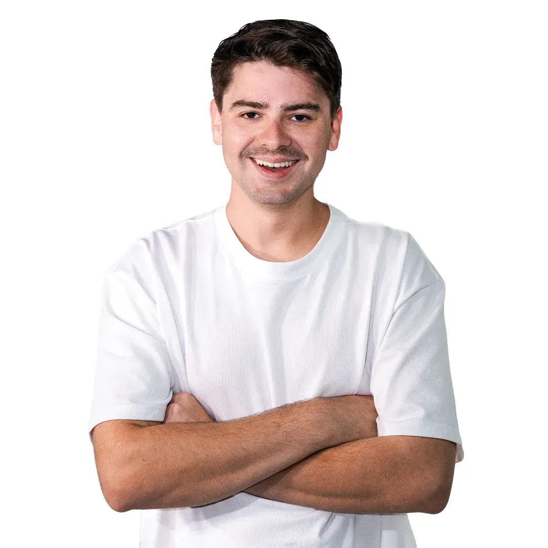 Smiling person in a white T-shirt with arms crossed on a white background