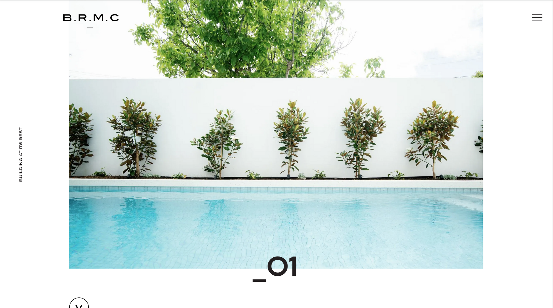 Minimalist poolside scene with white wall, potted greenery, and turquoise water