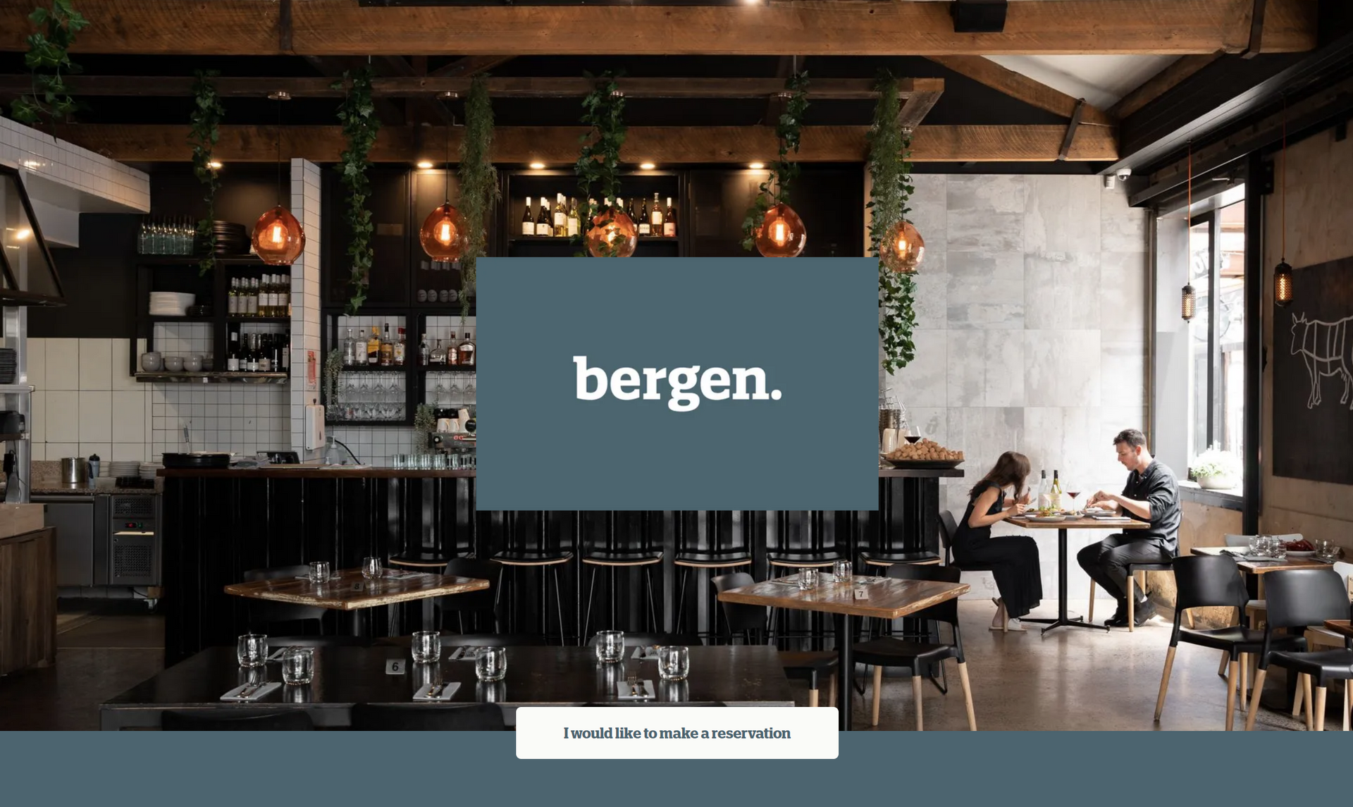 Café interior with wooden beams and hanging lights, featuring a central sign reading “bergen.”