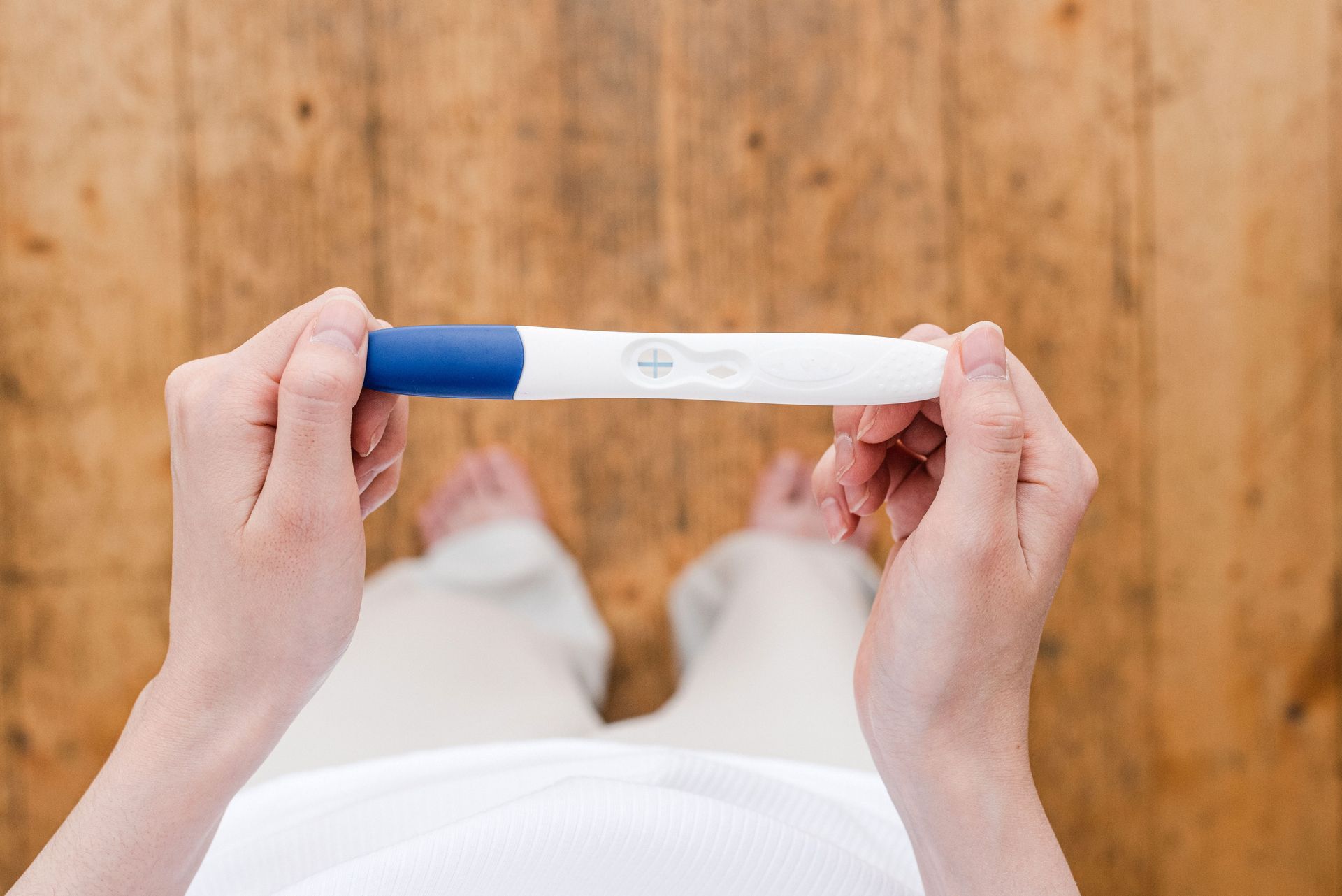 Woman holding positive pregnancy test