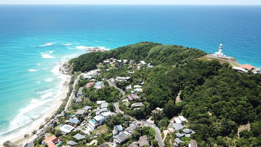 An Aerial View Of A Residential Area On A Cliff Overlooking The Ocean — Yves De Wilde Quality Painting Services In Byron Bay, NSW