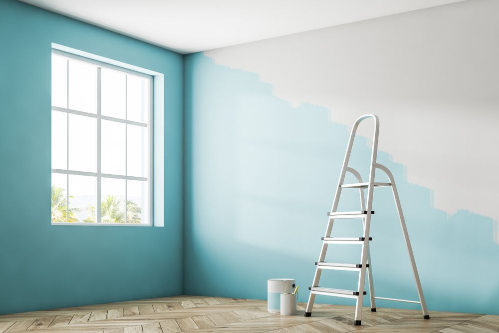 An Empty Room With Blue Walls And A Ladder — Yves De Wilde Quality Painting Services In Bangalow, NSW
