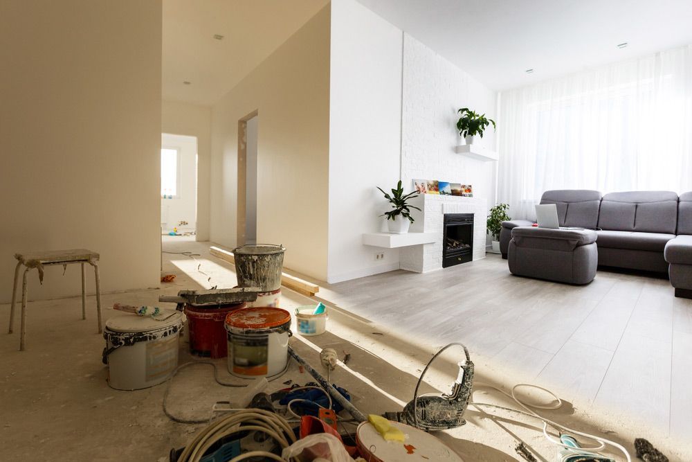 A Living Room With A Couch And A Fireplace Under Construction — Yves De Wilde Quality Painting Services In Bangalow, NSW