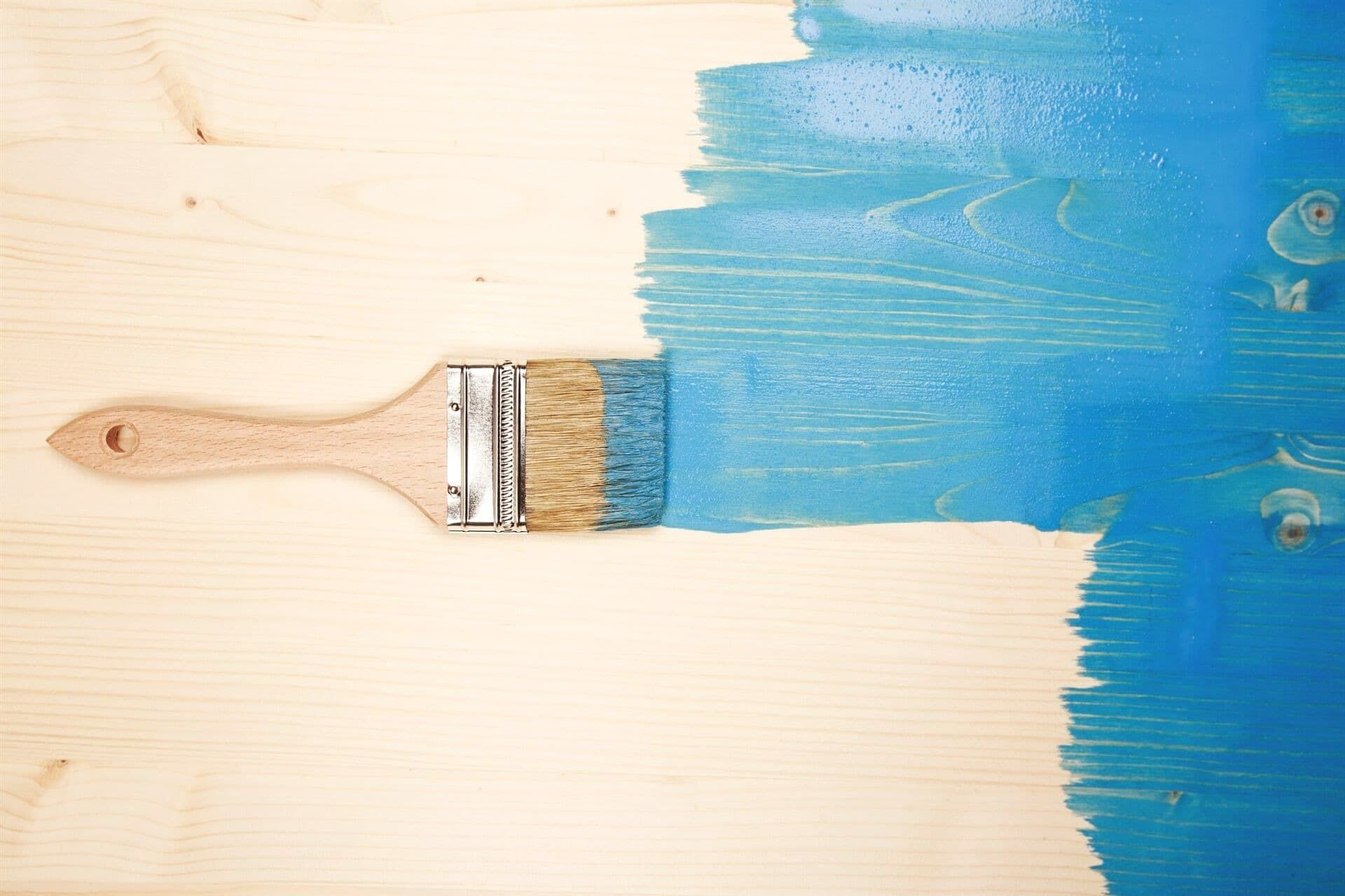A Paint Brush Is Being Used To Paint A Piece Of Wood — Yves De Wilde Quality Painting Services In Lismore, NSW