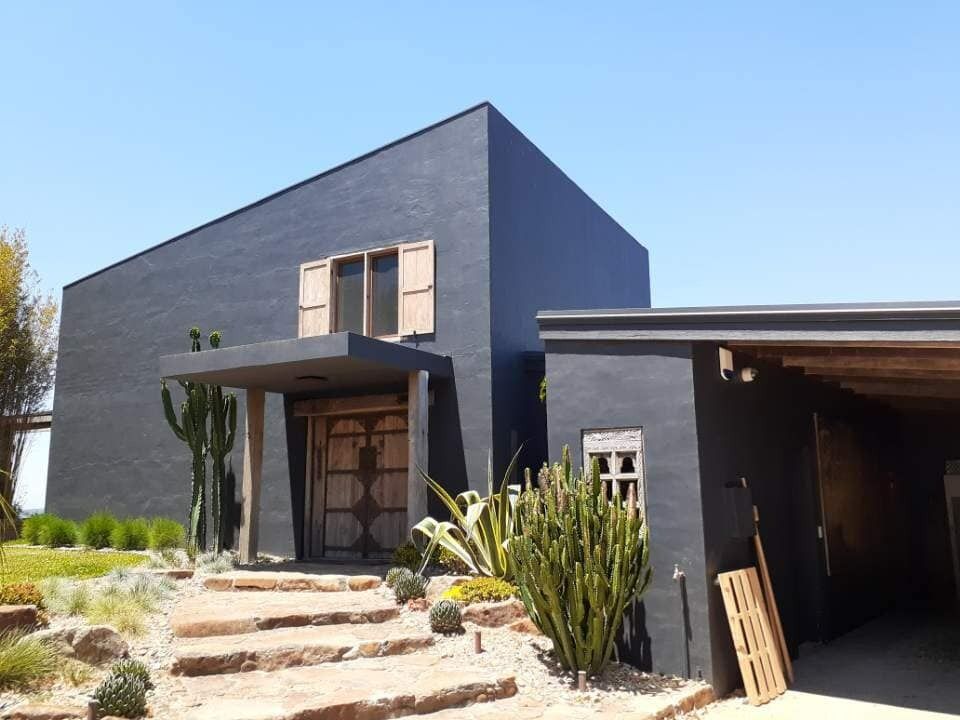 A Large Black House With Stairs Leading Up To It — Yves De Wilde Quality Painting Services In Lismore, NSW