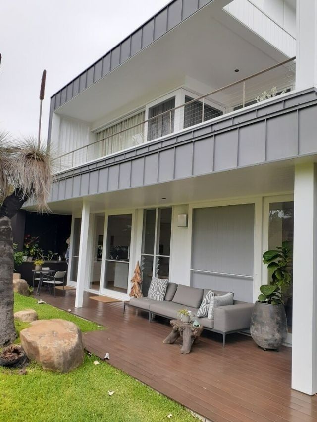 A Large White House With A Couch On The Porch — Yves De Wilde Quality Painting Services In Lismore, NSW