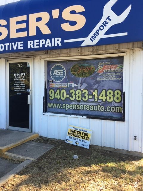 Auto repair shop storefront with blue sign, phone number, and website on the window | Spenser's Quality Automotive