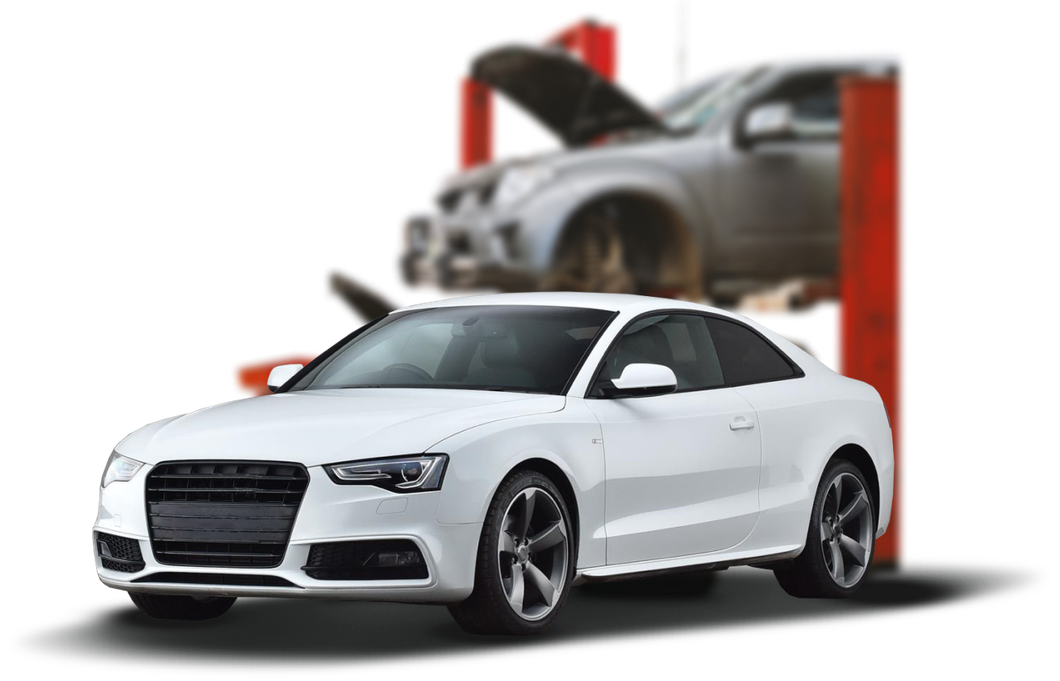 White sports coupe in front of a car lift with a blurred car in the background | OG Autoworks
