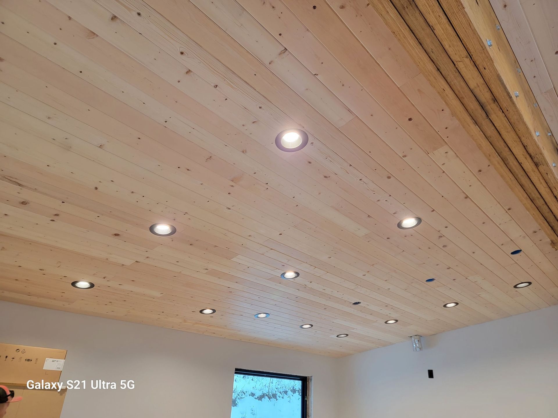A wooden ceiling with a lot of lights on it