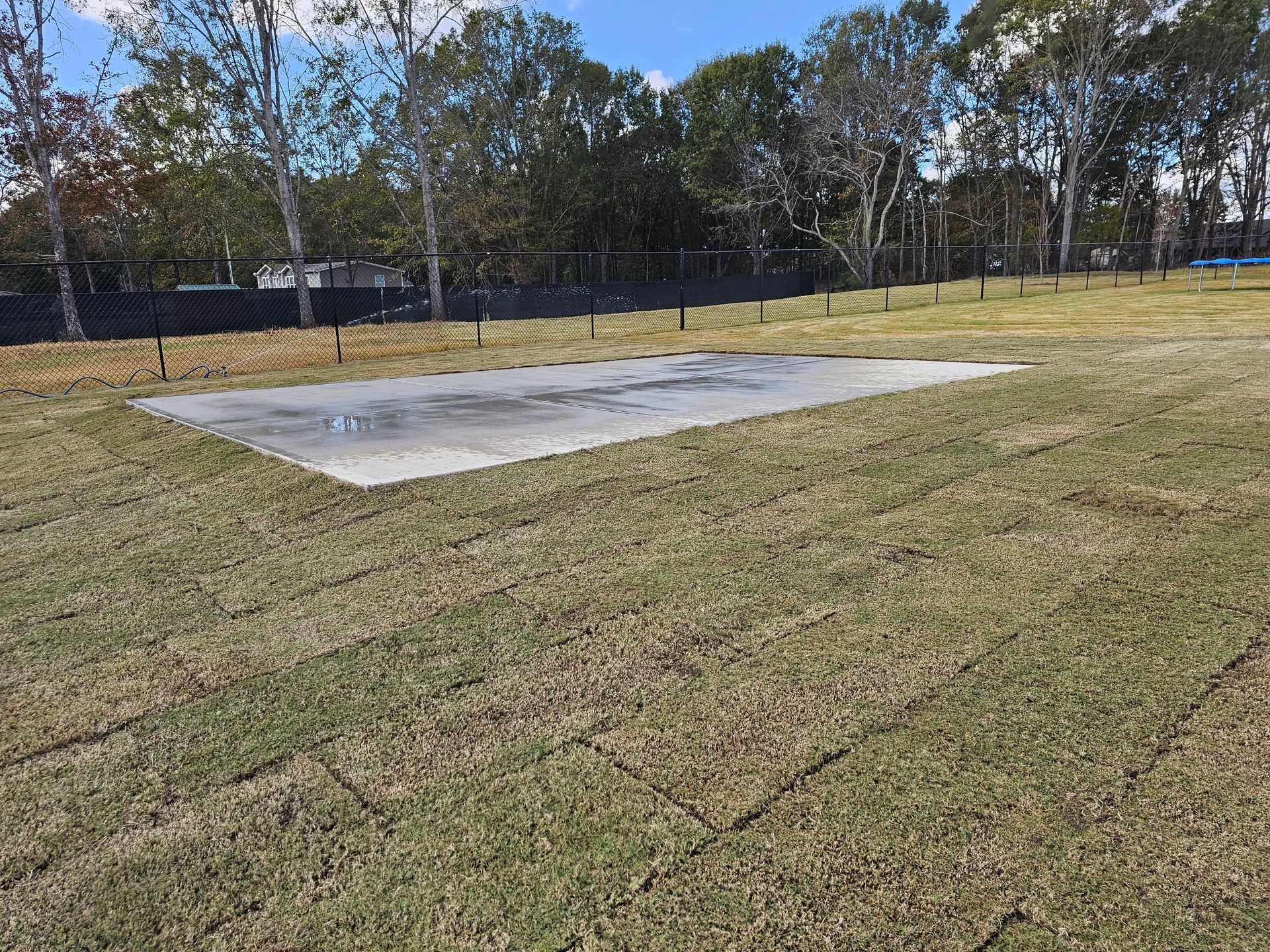 A large concrete slab is sitting in the middle of a grassy field woodruff 
