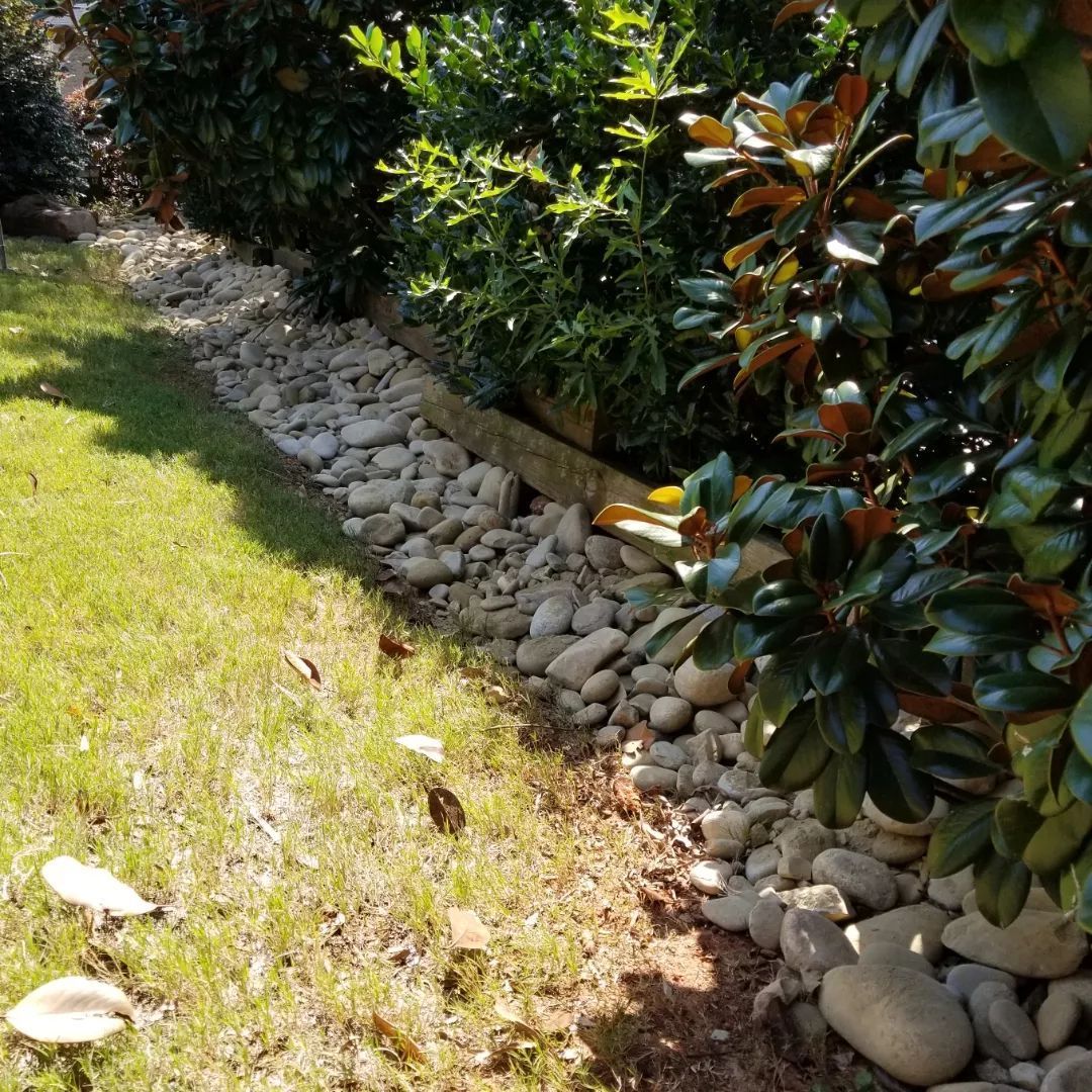 A lawn with rocks and trees in the background cherokee springs 