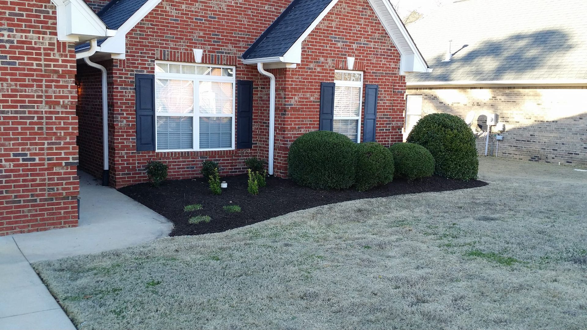 A brick house with a lush green lawn in front of it gaffney 