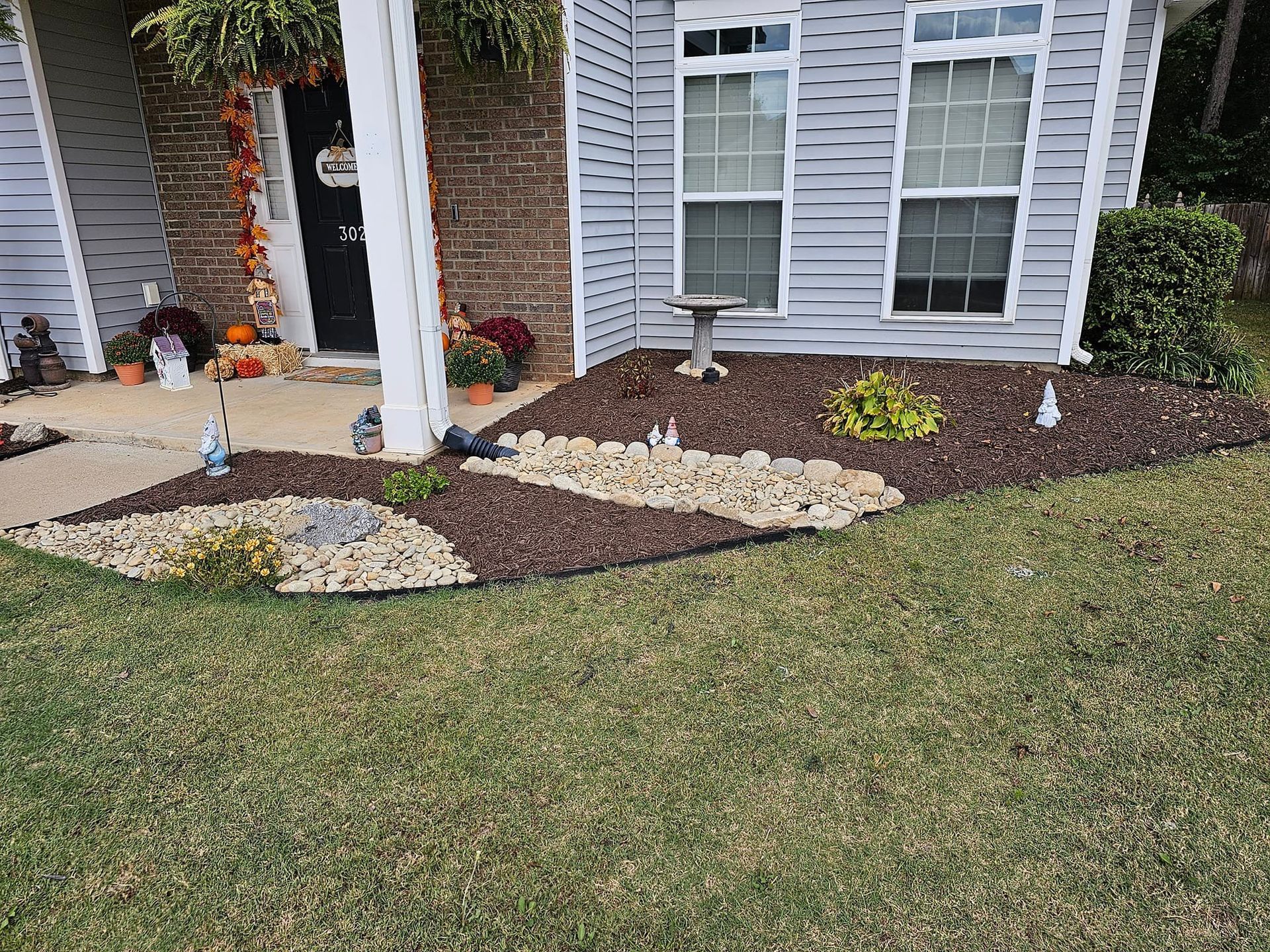 A house with a lush green lawn and a bird bath in front of it. cherokee springs 