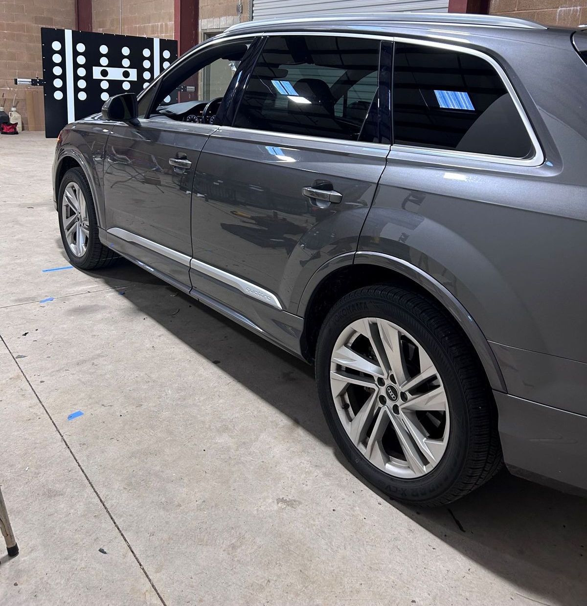 Windshield replacement & ADAS Calibration in Lincoln, CA Gray SUV parked in a garage, side view with tinted windows and alloy wheels