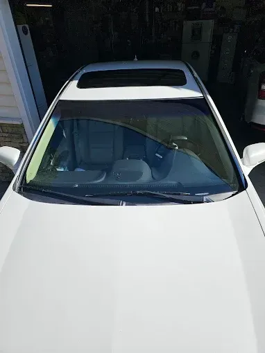 Sunroof replacement in Truckee, CA Sunroof Replacement in Truckee CA White car parked in a garage, front view with windshield visible