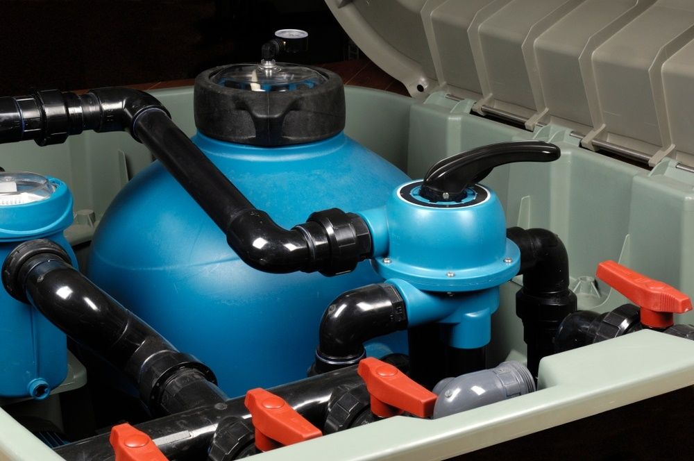 A Swimming Pool Filter Is In A Box With The Lid Open — Col Davies Pools In Warners Bay, NSW