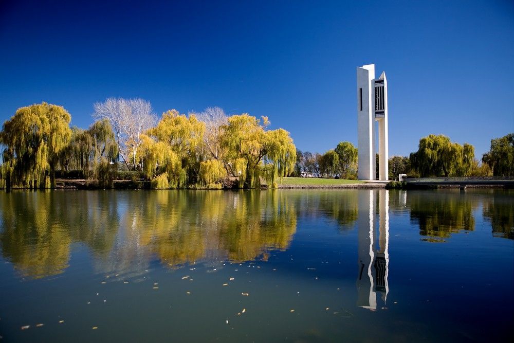 A Lake With Trees and a Tower in the Background — Capital Automotive Service in Canberra, ACT
