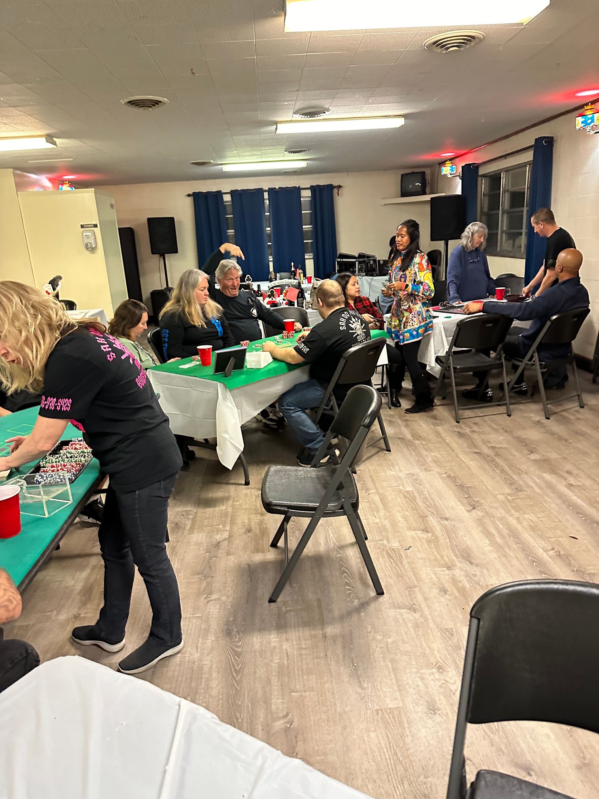 A group of people are sitting at tables in a room.