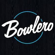 The bowlero logo is on a black wooden background.