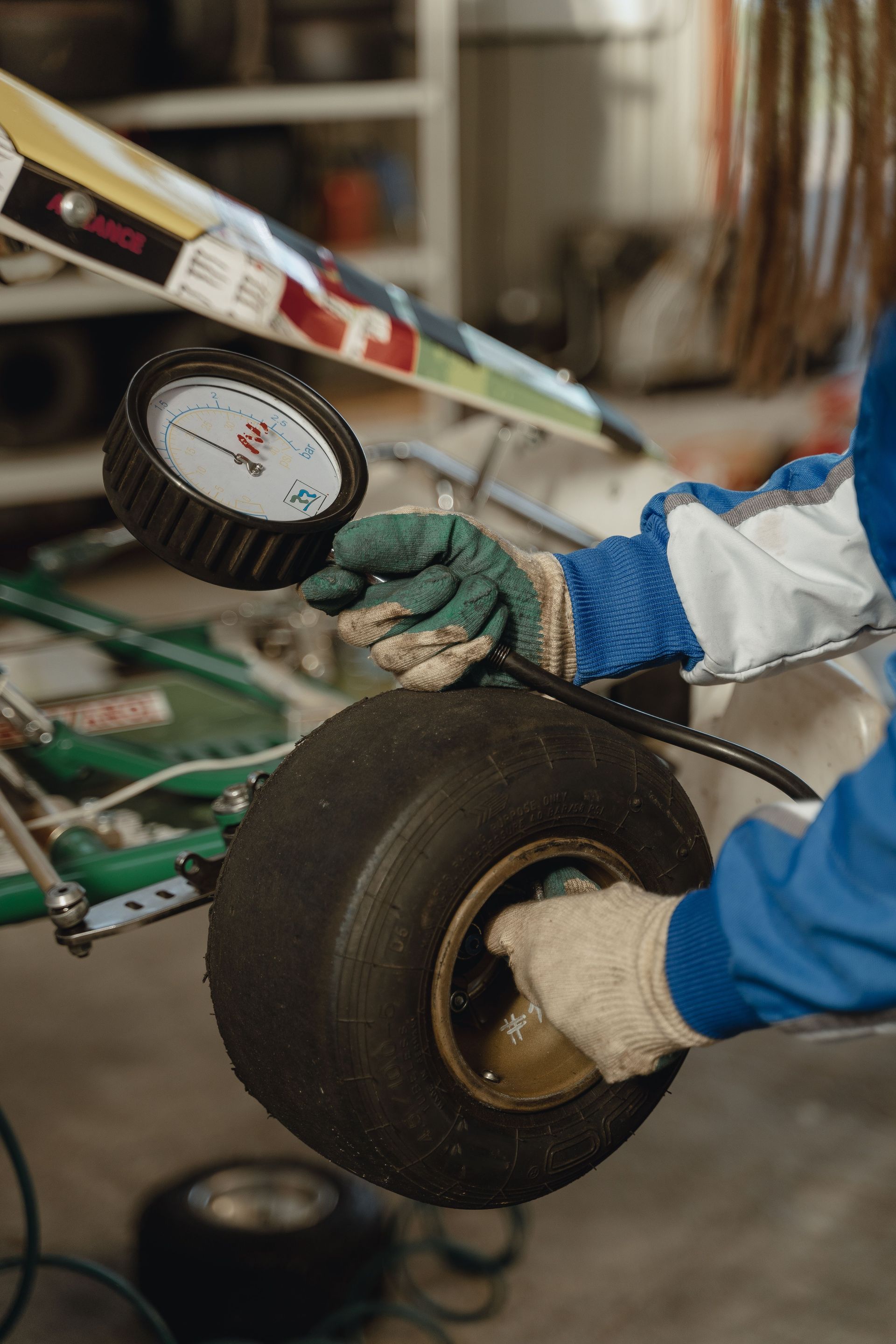 Gloved hands inspecting a wheel on a model aircraft in a workshop