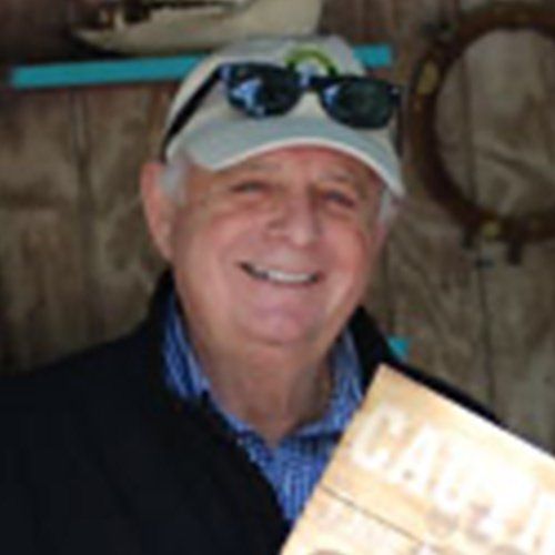 A man wearing a hat and sunglasses is holding a book titled california