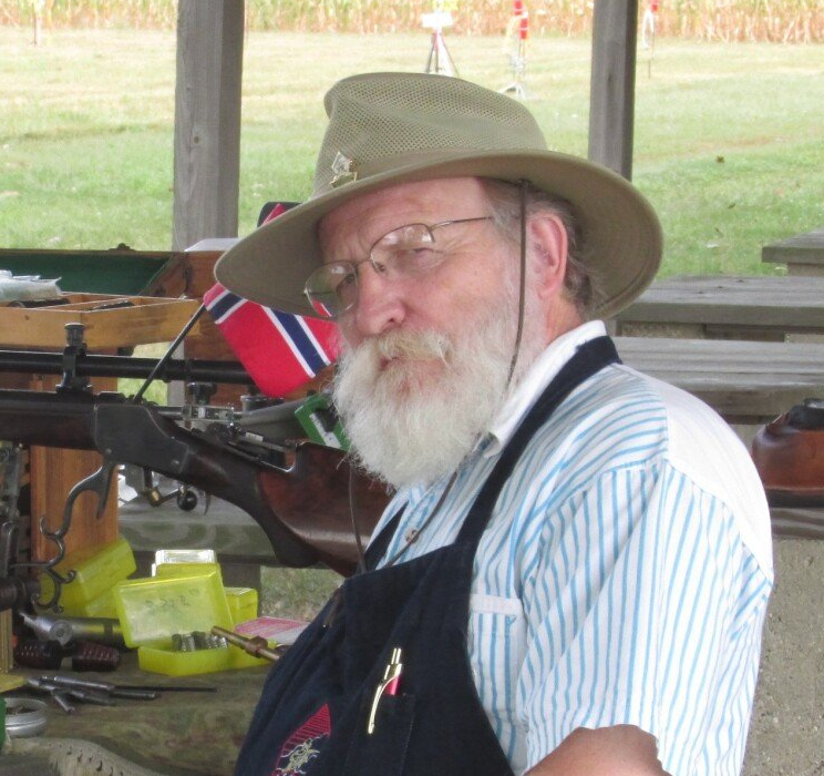 A man with a beard wearing a hat and glasses