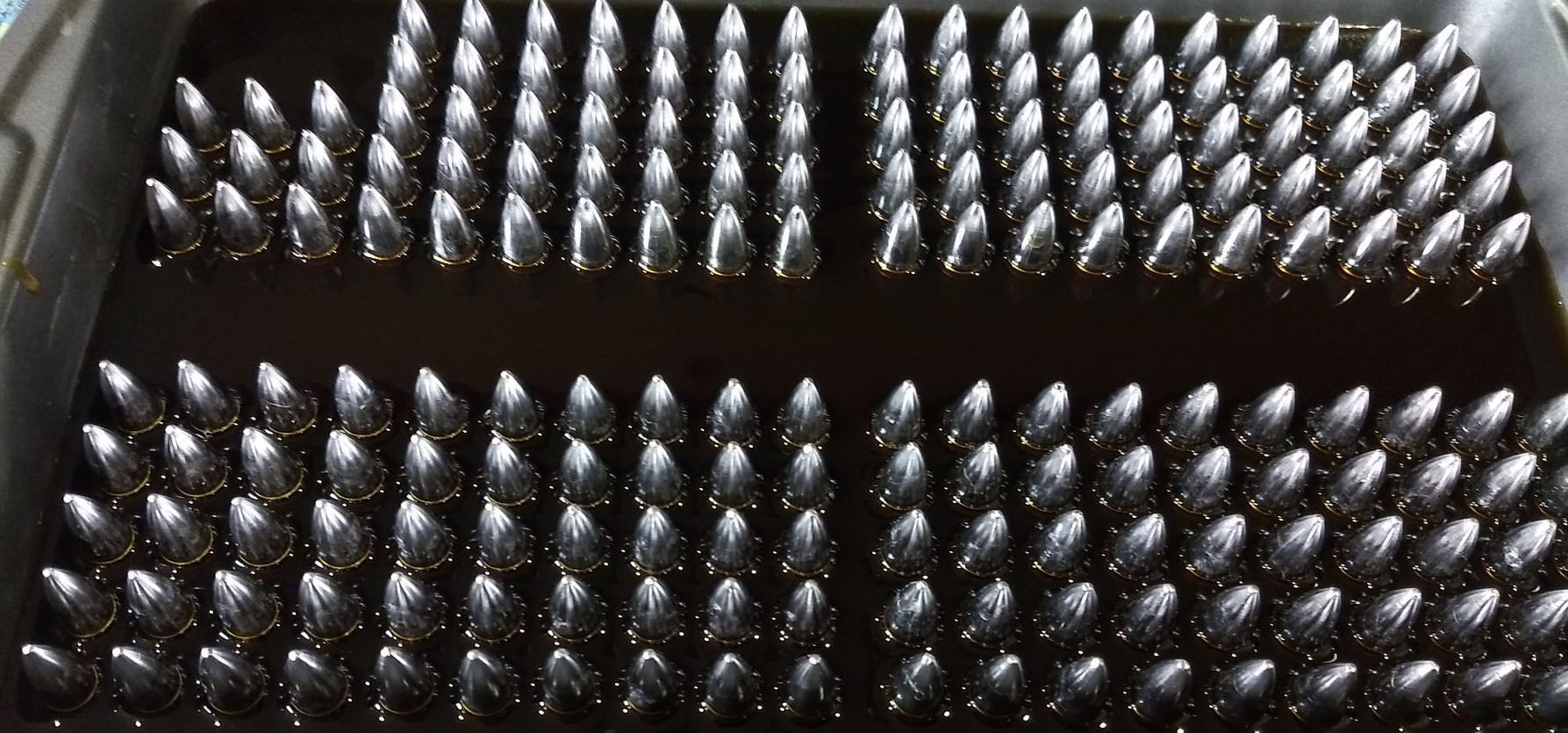 A bunch of spoons are lined up in a row