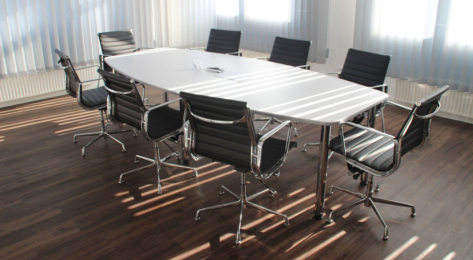 A conference room with a long table and chairs