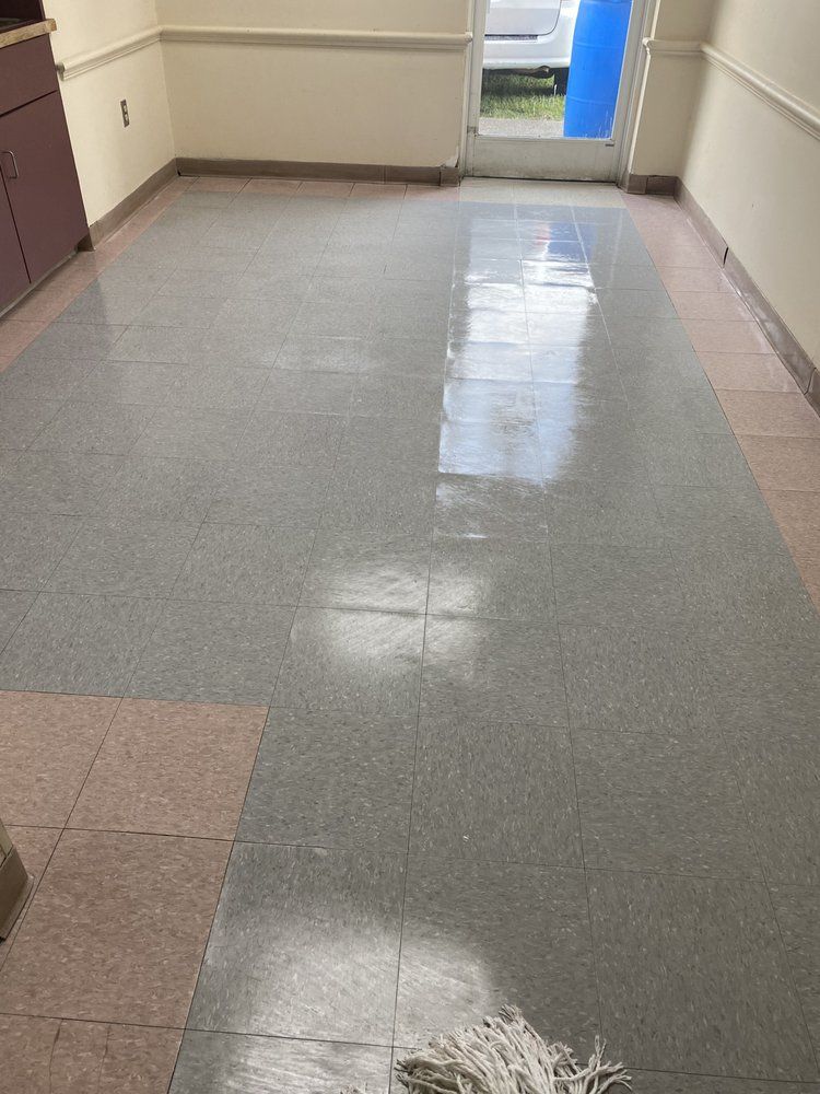 Gray tiled floor, entrance with door, cabinet.