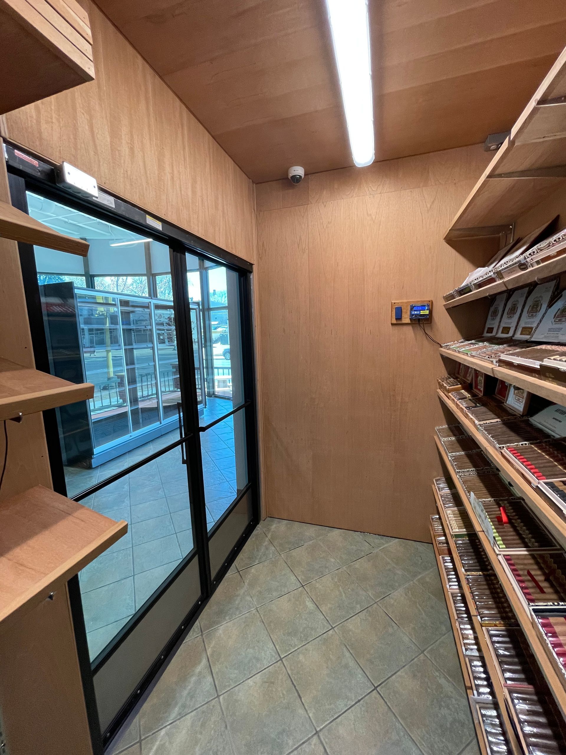 A room with a lot of shelves and a door.