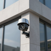 Security camera mounted on a modern building corner, overlooking the area