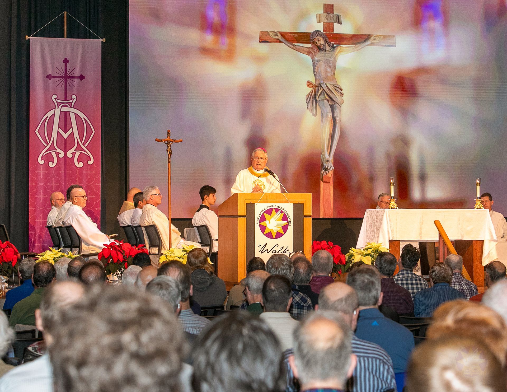 Church service with priest at lectern, crucifix above altar, and congregation seated in pews