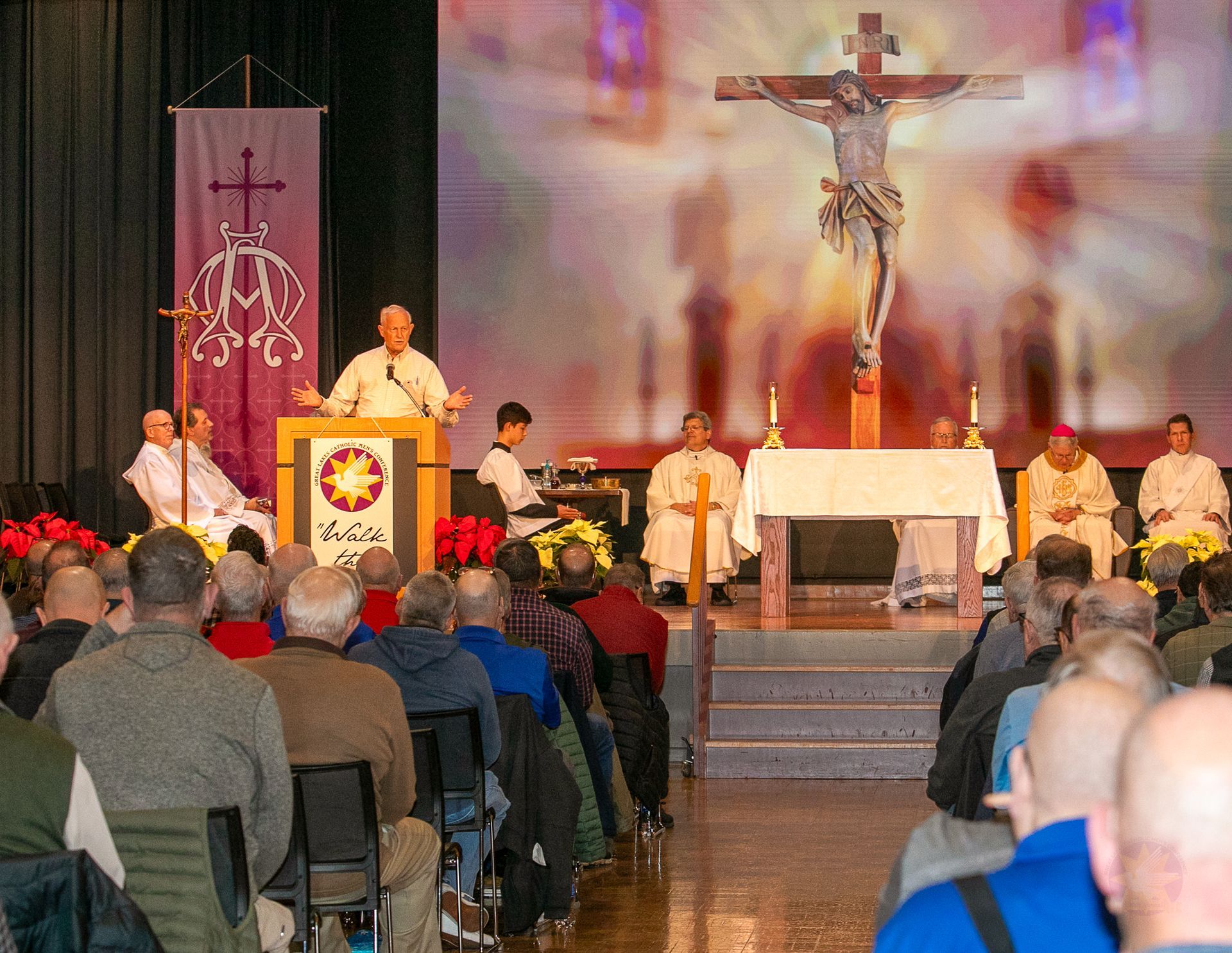 Church service with a reader at the lectern, altar and crucifix behind, congregation seated.