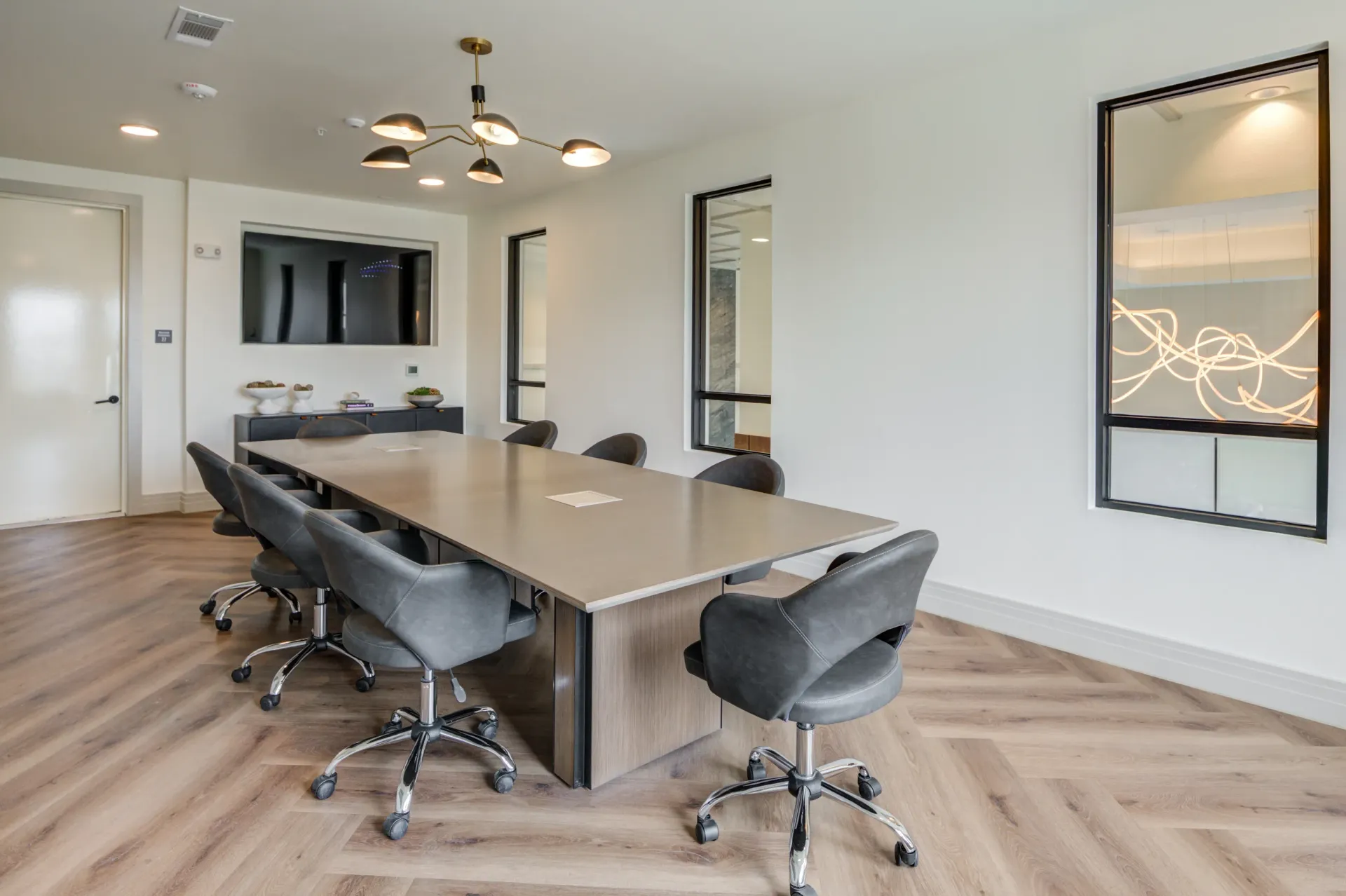 Modern conference room with a large table and chairs.