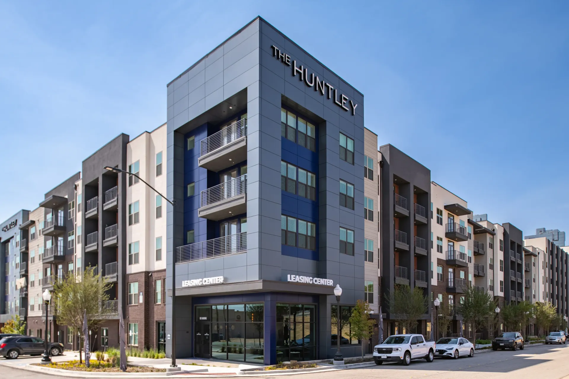 The Huntley apartment building exterior with leasing center entrance