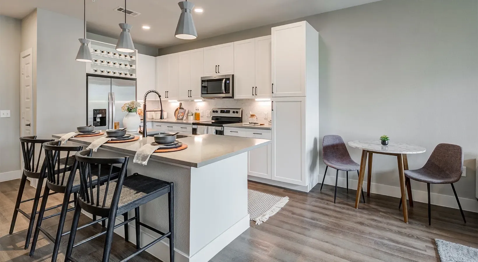 Modern kitchen with island seating and dining area.