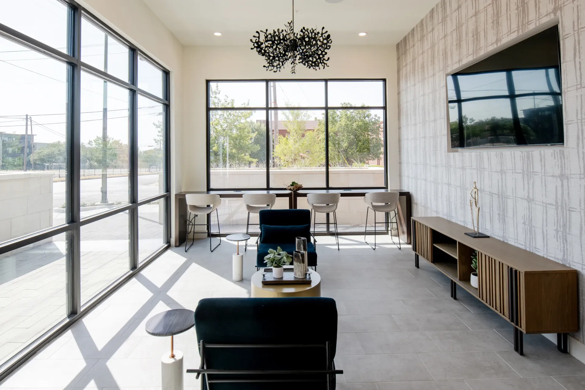 Modern lounge area with bar seating and a TV.