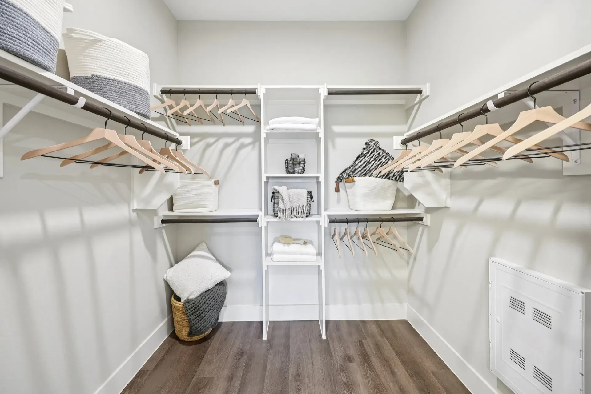 Spacious walk-in closet with ample shelving and hanging space.