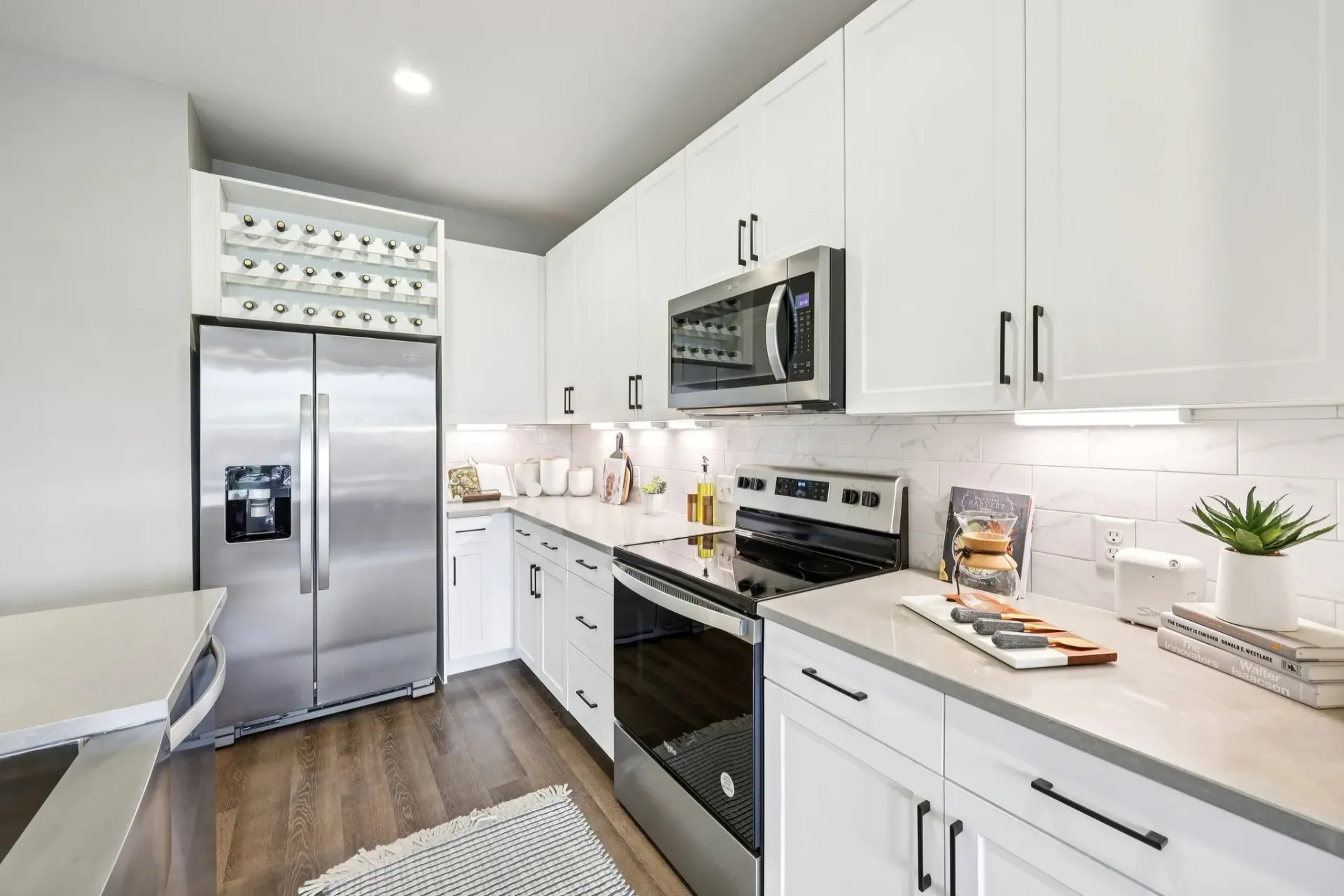 Modern kitchen with stainless steel refrigerator and oven.