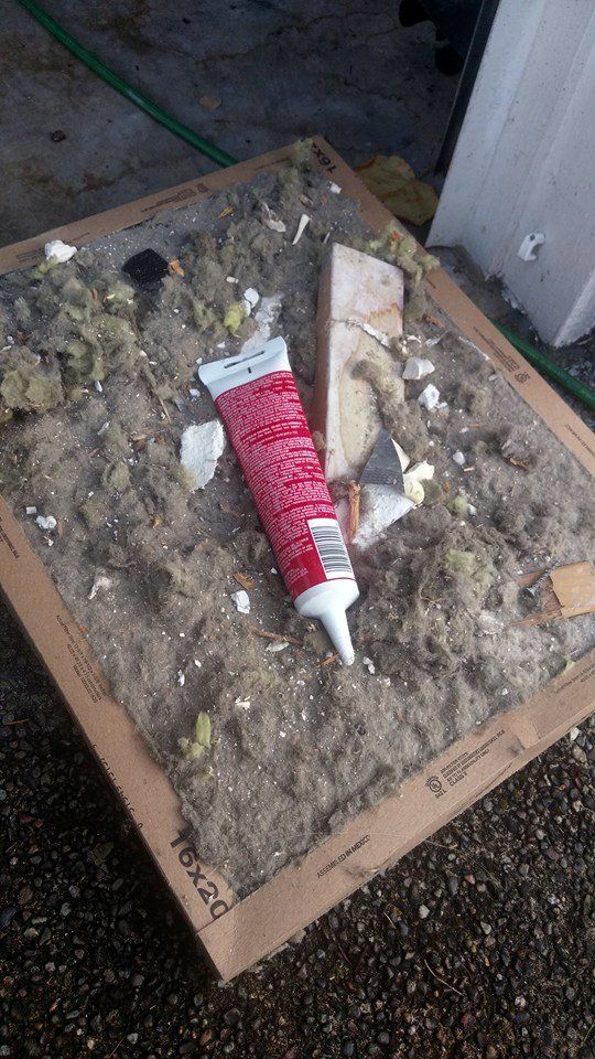 Dirty air filter with debris and a tube of caulk.