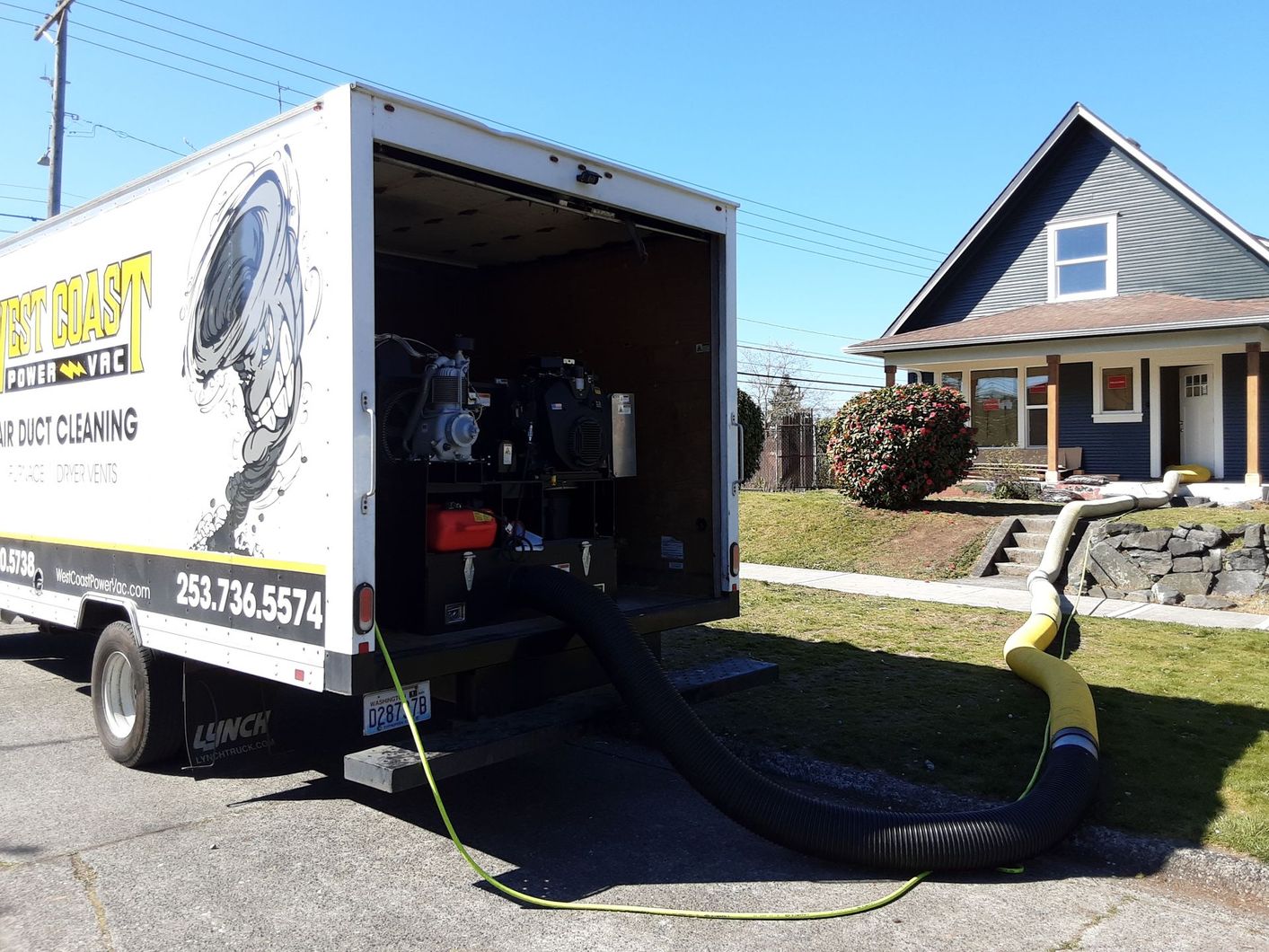Truck from West Coast Power Vac, with open back revealing equipment for air duct cleaning.