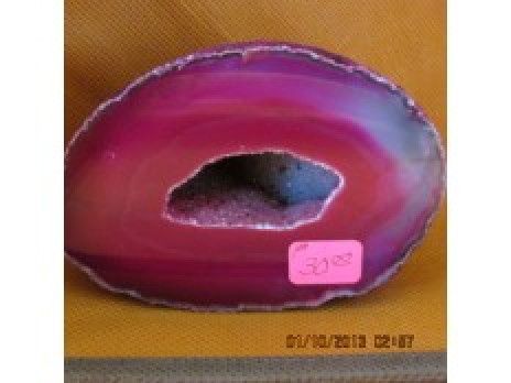 Pink and purple polished geode slice with a hollow center and small price tag
