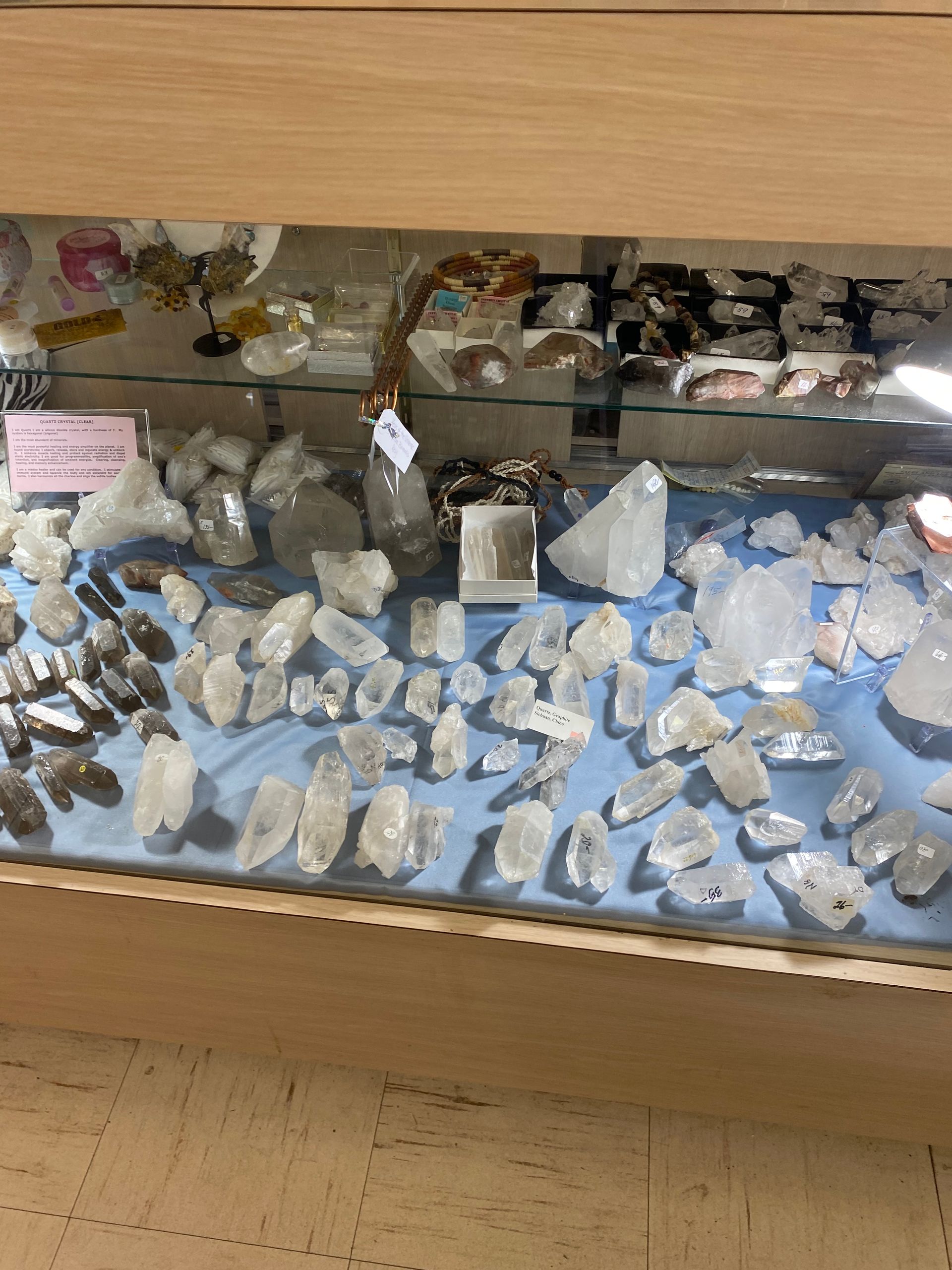 Display case of assorted blue and white rocks and crystals in a museum or shop setting