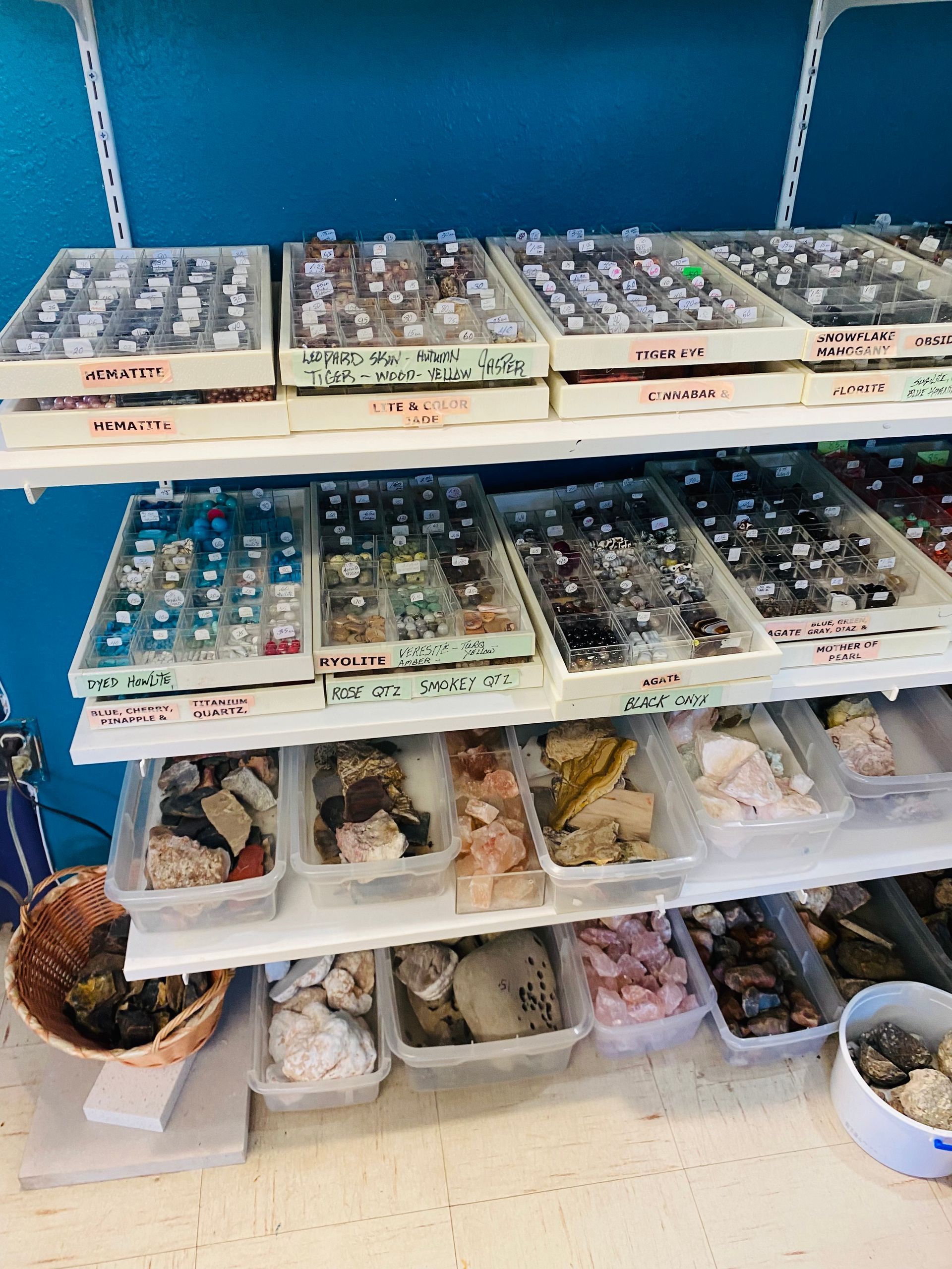 Shelves of small decorative bowls and trinkets arranged in rows on a store display rack