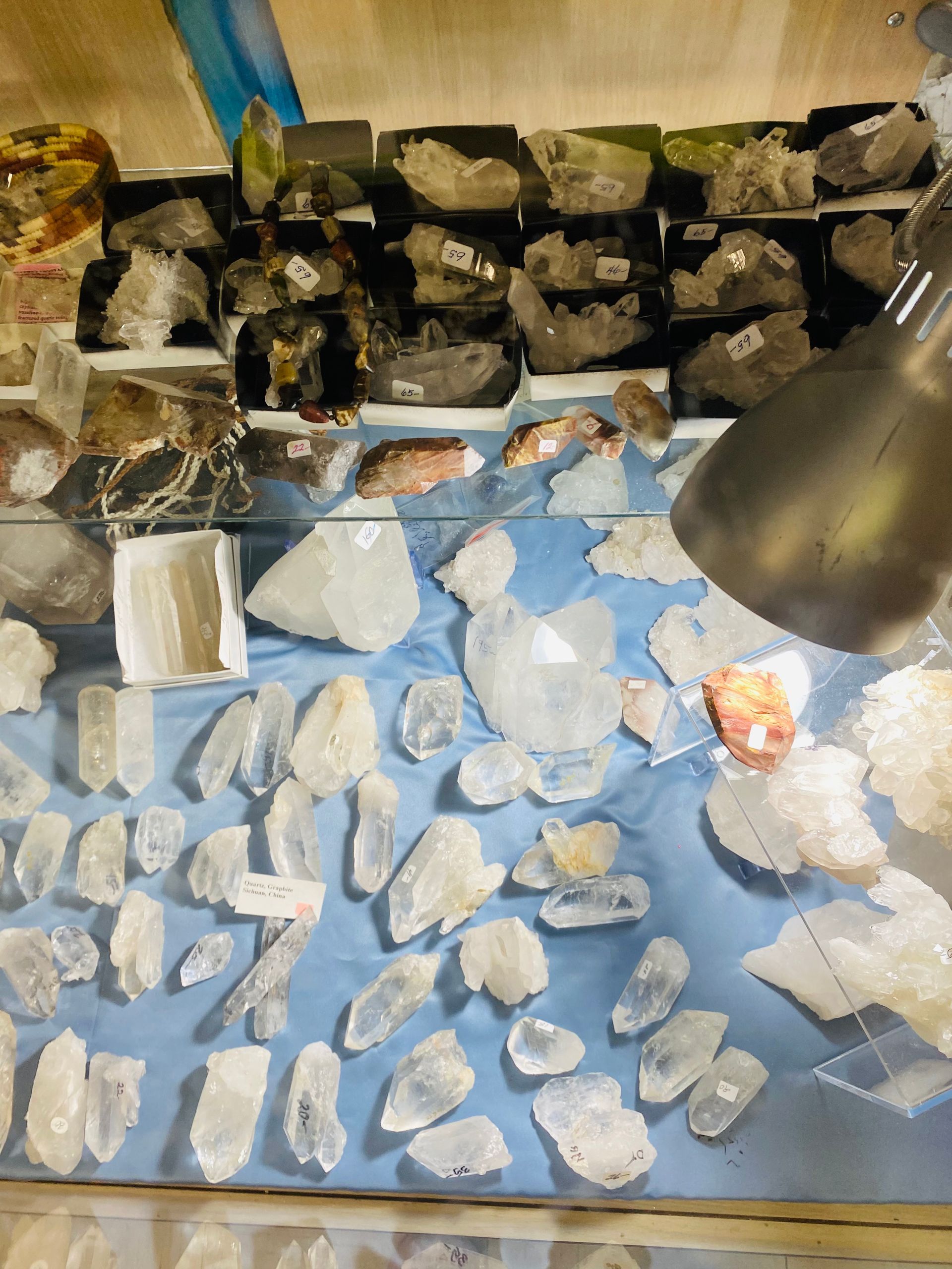 Blue tabletop covered with many small white stones and a lamp at the upper right