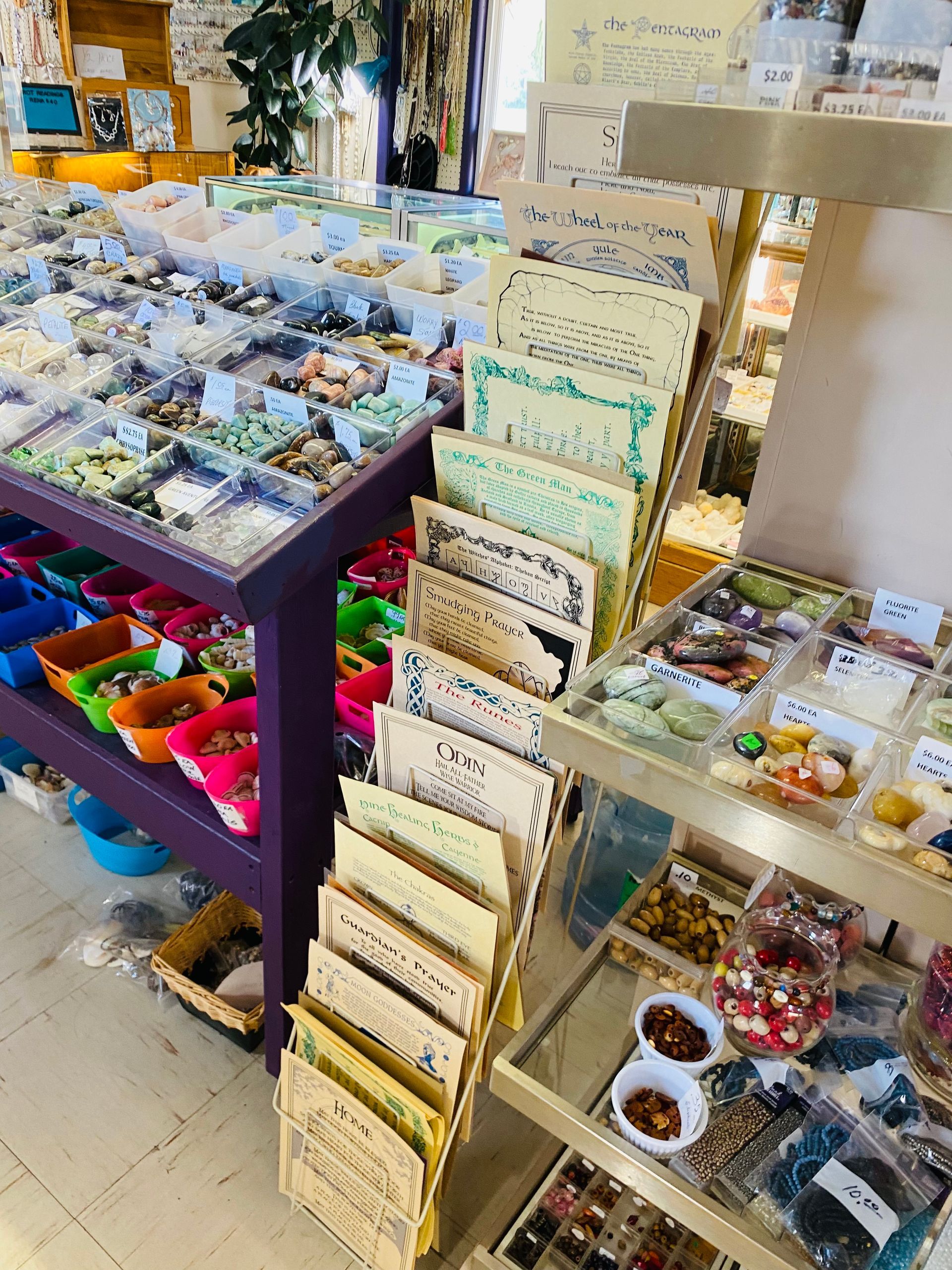 Display of packaged snacks and gift items on shelves in a bright shop aisle