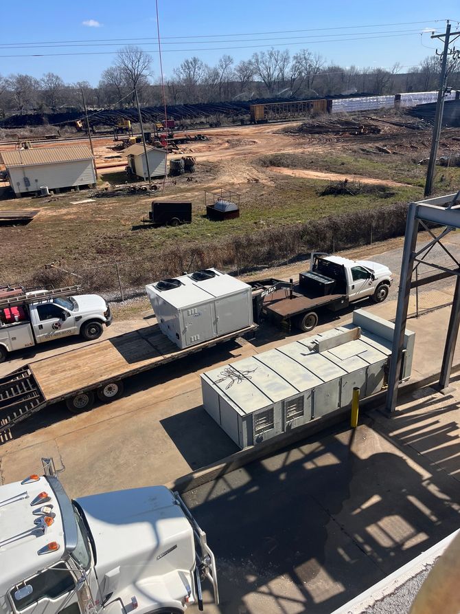 A bunch of trucks are parked on the side of the road.
